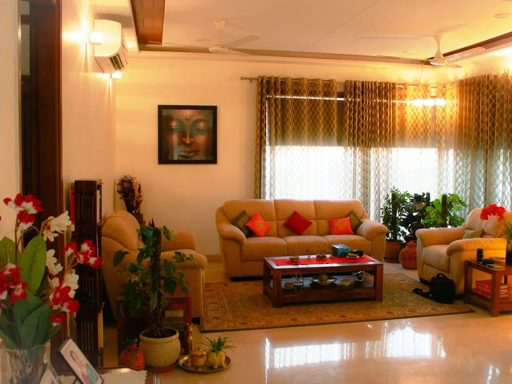 3 BHK living room interior with warm lighting, layered seating and traditional decor, designed for a Bangalore home