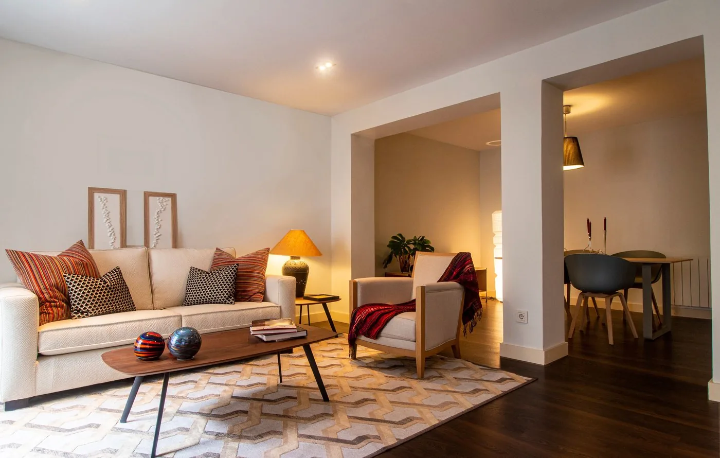 Warmly lit living room interior with open-plan dining area, designed and executed by interior designers in Bangalore